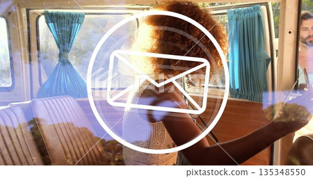 Driving woman with curly hair navigating retro camper van, with wood panels and light blue curtains Driving woman with curly hair navigating retro camper van, with wood panels and light blue curtains 135348550