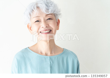 Senior woman standing in front of a wall Senior woman standing in front of a wall 135349057