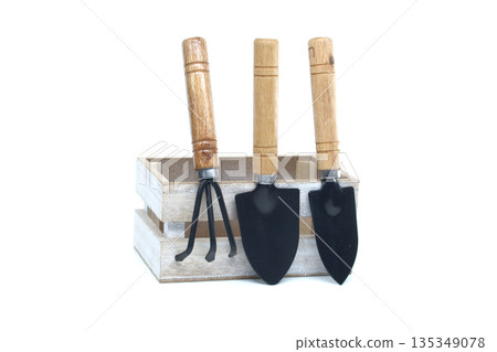 Gardening tools in a wooden crate on a white background, ready for planting Gardening tools in a wooden crate on a white background, ready for planting 135349078