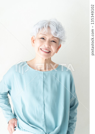 Senior woman standing in front of a wall 135349102