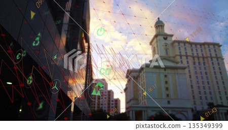 Displaying neoclassical tower beside glass tower at dusk downtown with digital icons and red graphs Displaying neoclassical tower beside glass tower at dusk downtown with digital icons and red graphs 135349399