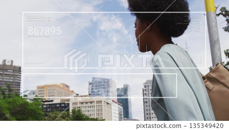 Walking woman wearing green top carrying tan backpack downtown, with hologram overlay, copy space Walking woman wearing green top carrying tan backpack downtown, with hologram overlay, copy space 135349420
