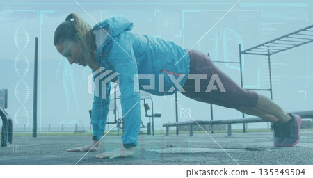Mid adult woman in sportswear performing push-up in outdoor gym, pull-up bars and fitness tracker Mid adult woman in sportswear performing push-up in outdoor gym, pull-up bars and fitness tracker 135349504