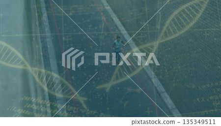 Jogger wearing blue top and hydration belt running along urban road, with glass panels, DNA overlay 135349511