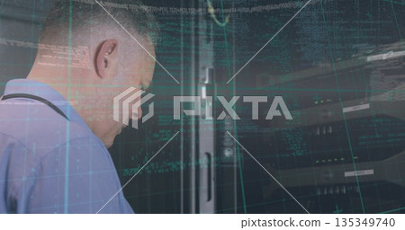 Standing IT technician monitoring server rack in data center, with blinking LED lights, copy space 135349740