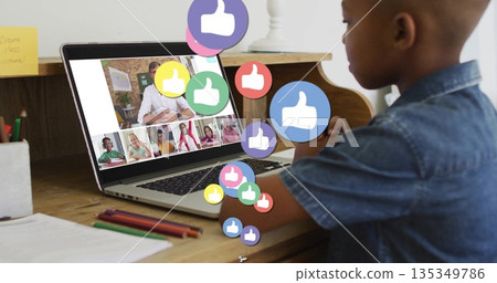 Typing boy on silver laptop at home, with pencils, notebook, thumbs up icons, copy space Typing boy on silver laptop at home, with pencils, notebook, thumbs up icons, copy space 135349786