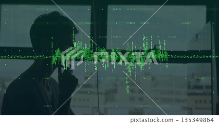 Talking on smartphone silhouette man by office window, green waveform overlay, markers, copy space 135349864