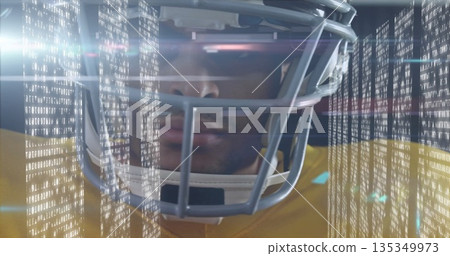 Standing helmeted athlete wearing yellow jersey scanning binary code in studio, with flare streaks Standing helmeted athlete wearing yellow jersey scanning binary code in studio, with flare streaks 135349973
