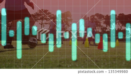 Controlling coach guiding soccer ball on sunset field with cones and waveform overlay, copy space 135349980