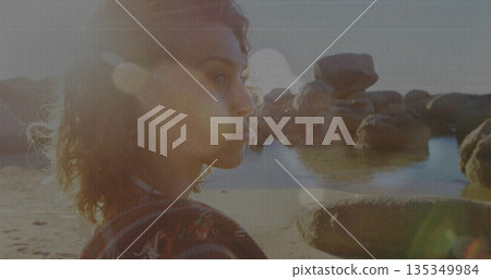 Standing woman gazing at sunset beach, with granite boulders, tide pools and lens flare, copy space Standing woman gazing at sunset beach, with granite boulders, tide pools and lens flare, copy space 135349984