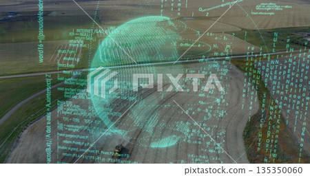 Hovering translucent turquoise digital globe above rural farmland, with streaming code overlay 135350060