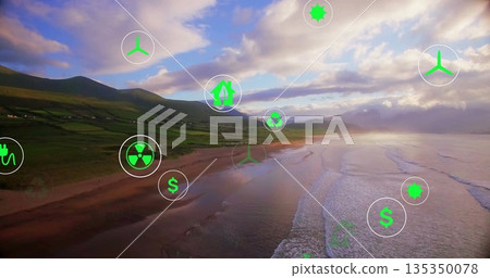 Showing wind, solar, recycling, radiation and dollar icons floating over coastal beach at dusk Showing wind, solar, recycling, radiation and dollar icons floating over coastal beach at dusk 135350078