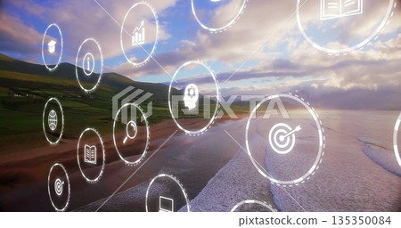 Floating cluster of digital icons moving over sunset beach, with business education symbols Floating cluster of digital icons moving over sunset beach, with business education symbols 135350084
