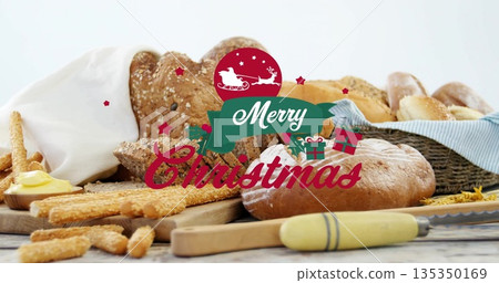 Featuring seeded loaf, baguettes on kitchen tabletop, with butter dish, Merry Christmas graphic Featuring seeded loaf, baguettes on kitchen tabletop, with butter dish, Merry Christmas graphic 135350169