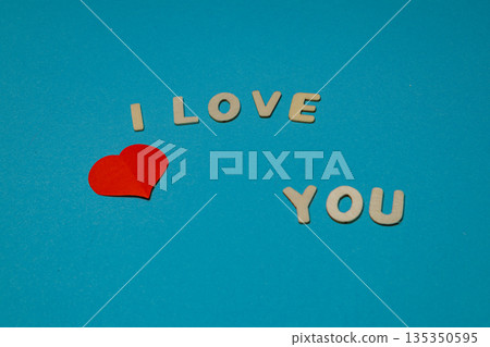 Letters and heart form a message on a blue background Letters and heart form a message on a blue background 135350595