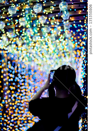 [Tobishima Village, Aichi Prefecture] A woman looks at the spectacular view of Tobishima Yoi Akari wind chimes and illuminations 135350806