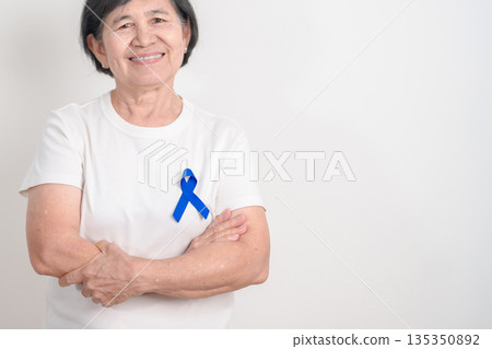 Elderly with dark Blue or Navy blue Ribbon for concept of March Colorectal and Colon Cancer Awareness month, May Arthritis awareness, July Juvenile arthritis and Childhood. Health and world cancer day Elderly with dark Blue or Navy blue Ribbon for concept of March Colorectal and Colon Cancer Awareness month, May Arthritis awareness, July Juvenile arthritis and Childhood. Health and world cancer day 135350892