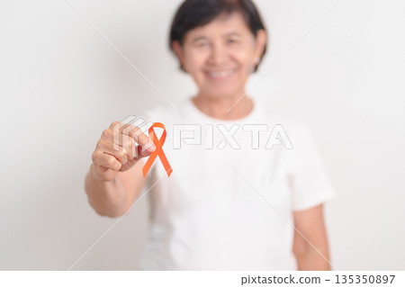 Elderly with Orange Ribbon for September Leukemia, March Kidney cancer day, Multiple Sclerosis, Self Injury Awareness month, November Complex Regional Pain Syndrome, CRPS, COPD disease concept Elderly with Orange Ribbon for September Leukemia, March Kidney cancer day, Multiple Sclerosis, Self Injury Awareness month, November Complex Regional Pain Syndrome, CRPS, COPD disease concept 135350897