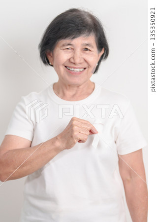 Elderly with White ribbon for concept November Lung Cancer Awareness month, Stop Violence Against Women, Adoption, May Retinoblastoma, Action for Women Health, March Remembrance, October Osteoporosis Elderly with White ribbon for concept November Lung Cancer Awareness month, Stop Violence Against Women, Adoption, May Retinoblastoma, Action for Women Health, March Remembrance, October Osteoporosis 135350921