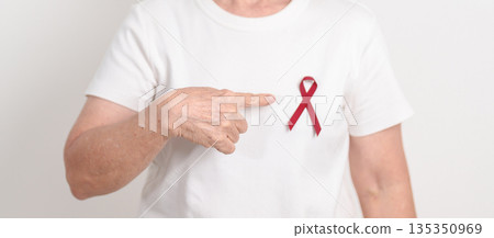 Elderly with Burgundy Ribbon for March Multiple Myeloma Cancer Awareness month, September Sickle Cell Anemia, Headache and Migraine week, April world Meningitis day, October Hospice Palliative care Elderly with Burgundy Ribbon for March Multiple Myeloma Cancer Awareness month, September Sickle Cell Anemia, Headache and Migraine week, April world Meningitis day, October Hospice Palliative care 135350969