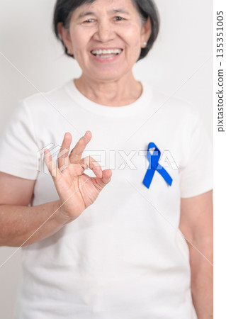 Elderly with dark Blue or Navy blue Ribbon for concept of March Colorectal and Colon Cancer Awareness month, May Arthritis awareness, July Juvenile arthritis and Childhood. Health and world cancer day Elderly with dark Blue or Navy blue Ribbon for concept of March Colorectal and Colon Cancer Awareness month, May Arthritis awareness, July Juvenile arthritis and Childhood. Health and world cancer day 135351005
