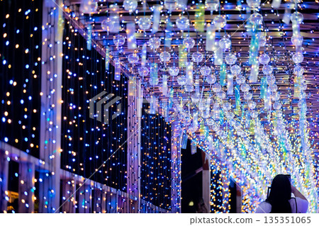 [Tobishima Village, Aichi Prefecture] A woman takes a photo of the spectacular view of wind chimes and illuminations with her smartphone at Tobishima Yoi Akari 135351065