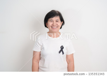 Elderly with Black ribbon for May Melanoma and skin cancer Awareness month, October Vaccine injury awareness month, Mourning Remembrance, March Sleep awareness week, Gang Prevention and Anti Violence Elderly with Black ribbon for May Melanoma and skin cancer Awareness month, October Vaccine injury awareness month, Mourning Remembrance, March Sleep awareness week, Gang Prevention and Anti Violence 135351343