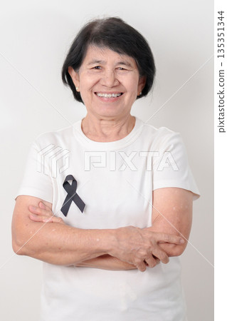Elderly with Black ribbon for May Melanoma and skin cancer Awareness month, October Vaccine injury awareness month, Mourning Remembrance, March Sleep awareness week, Gang Prevention and Anti Violence Elderly with Black ribbon for May Melanoma and skin cancer Awareness month, October Vaccine injury awareness month, Mourning Remembrance, March Sleep awareness week, Gang Prevention and Anti Violence 135351344