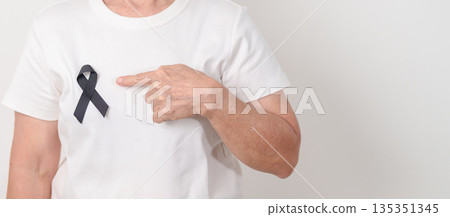 Elderly with Black ribbon for May Melanoma and skin cancer Awareness month, October Vaccine injury awareness month, Mourning Remembrance, March Sleep awareness week, Gang Prevention and Anti Violence 135351345