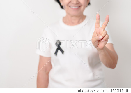 Elderly with Black ribbon for May Melanoma and skin cancer Awareness month, October Vaccine injury awareness month, Mourning Remembrance, March Sleep awareness week, Gang Prevention and Anti Violence 135351346