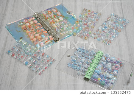 A girl putting 3D stickers into a sticker book 135352475