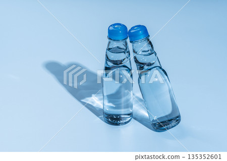 A glass bottle of ramune with blue and shadow marbles that conveys the cool feeling of summer 135352601