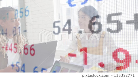 Reviewing man in blazer, woman in overalls checking financial overlay in office, with laptop pencil Reviewing man in blazer, woman in overalls checking financial overlay in office, with laptop pencil 135352771