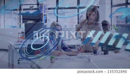 Reviewing prints, two women pointing at layouts in office beside succulent, with digital overlays Reviewing prints, two women pointing at layouts in office beside succulent, with digital overlays 135352840