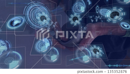 Holding coffee mug, tech professional studying holographic data visuals on wooden desk in office Holding coffee mug, tech professional studying holographic data visuals on wooden desk in office 135352876