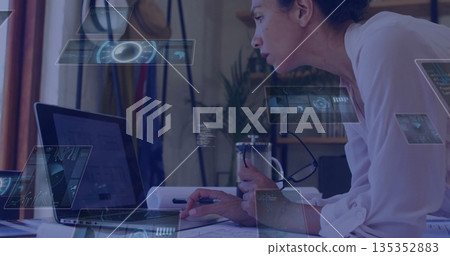 Leaning woman wearing blouse focusing on laptop at home office, holding French press amid overlays Leaning woman wearing blouse focusing on laptop at home office, holding French press amid overlays 135352883