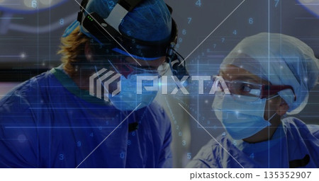 Working surgeons wearing masks and gowns, examining patient in operating room, with digital overlay 135352907