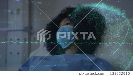 Reclining patient on hospital bed wearing surgical mask and medical gown, displaying data graphics 135352910