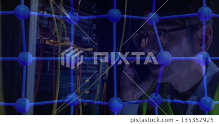 Holding smartphone technician managing digital network nodes in server room with cables, copy space 135352925