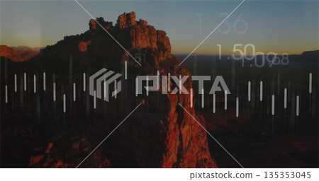 Displaying rocky cliff formation glowing in desert plateau at dusk, with translucent bars overlay 135353045