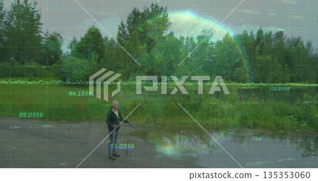 Standing woman surveying gravel clearing at water edge, with puddles, data grid overlay, copy space 135353060