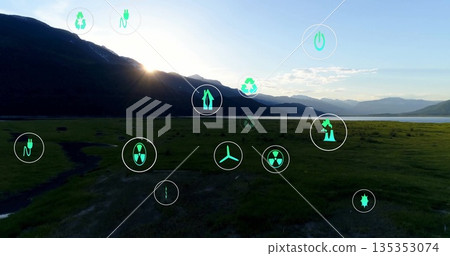Displaying mountain ridge overlaying sustainability and energy icons over plain and lake at sunrise 135353074