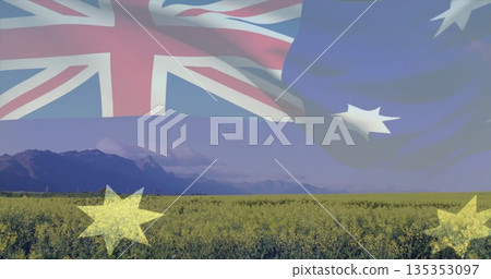 Displaying Australian flag merging into canola field in clear sky with mountain backdrop Displaying Australian flag merging into canola field in clear sky with mountain backdrop 135353097