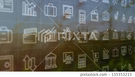 Floating financial icon grid including bar chart piggy bank on office glass panel, rural view Floating financial icon grid including bar chart piggy bank on office glass panel, rural view 135353215