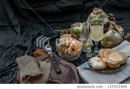 Peel toddy palm and fresh palm juice at front of dark background. 135353409