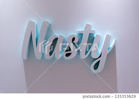 Nasty neon sign illuminated against a light wall in urban interior design space at Changi Airport Singapore 135353629