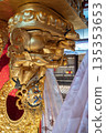 Golden statue of deity at Buddha Tooth Relic Temple in Chinatown, Singapore with intricate details and vibrant colors 135353653