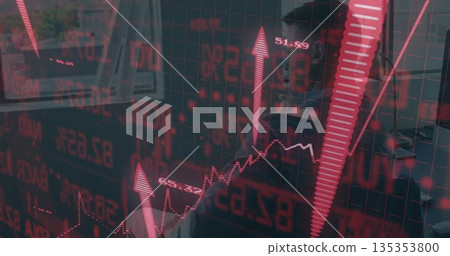 Analyst wearing tie analyzing live trading overlays at desk in office with laptop smartphone 135353800