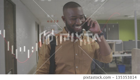 Walking man wearing mustard shirt and backpack through office hallway, speaking on smartphone Walking man wearing mustard shirt and backpack through office hallway, speaking on smartphone 135353814