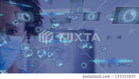 Masked nurse in scrubs using holographic panels with charts, code in hospital corridor, copy space 135353835